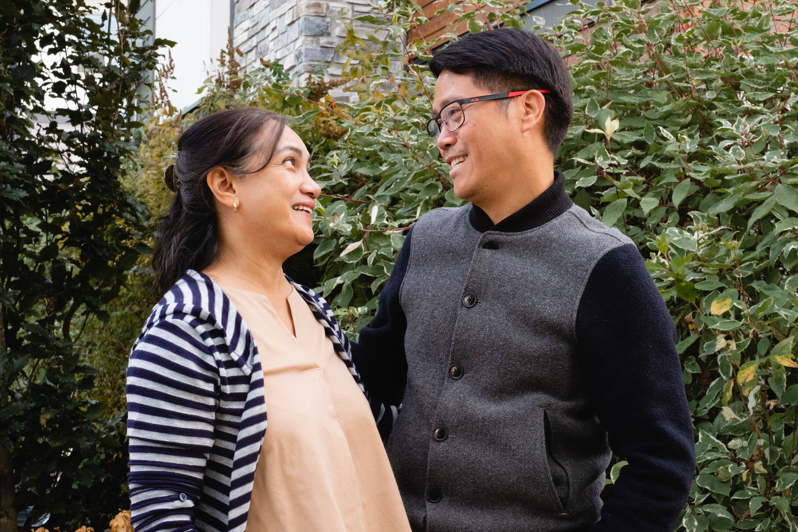 Two people sharing a warm look in the garden