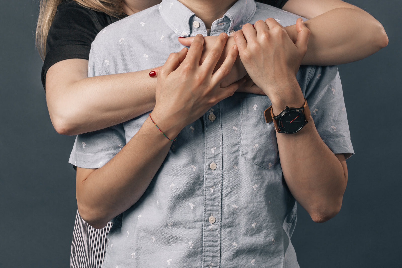Two people in a close, warm embrace outdoors